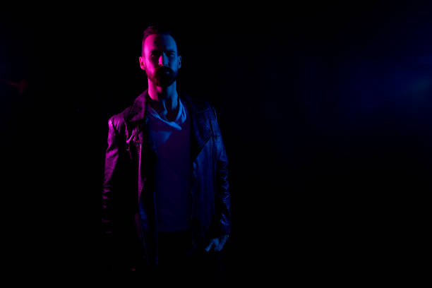 istock Attractive man with white shirt and leather jacket and gel lighting 1138190078