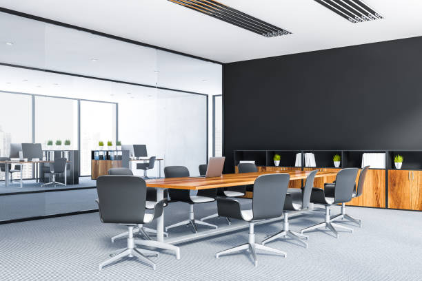 istock Black meeting room corner with wooden table 1138191360