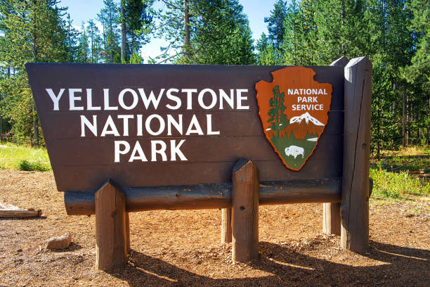 Yellowstone National Park Sign West Yellowstone, USA - 12 07 2015:  Yellowstone National Park: West Entrance sign upper geyser basin stock pictures, royalty-free photos & images