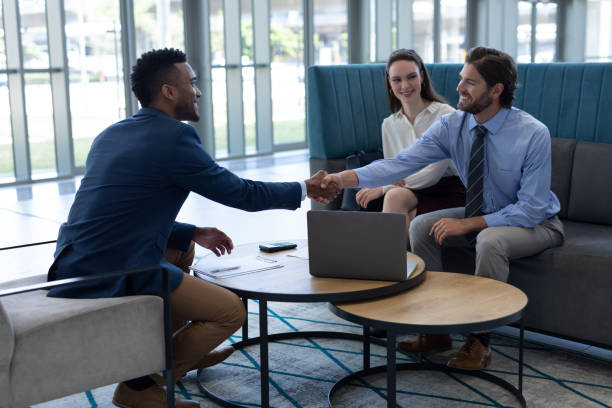 istock Multi-ethnic business people shaking hands with each other in the lobby 1138192229