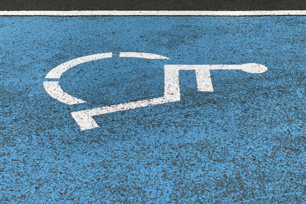istock sign parking for the disabled on asphalt, close-up 1138192858