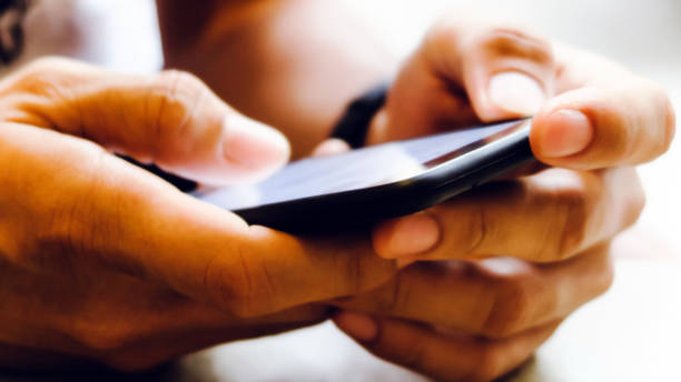 istock Closeup Image of man's hand holding a smartphone 1138193053
