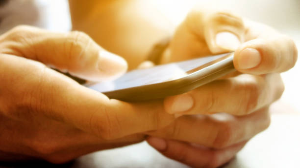 Closeup Image of man's hand holding a smartphone