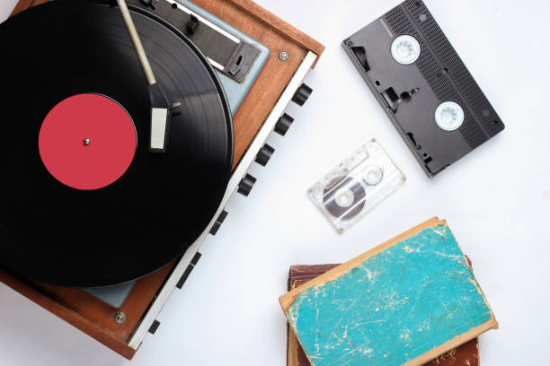 istock Pop culture retro objects on white background. Vinyl record player, old books, audio, video cassettes. Top view, media, flat lay 1138193750