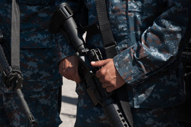 istock Soldier holding a machine with automatic gun.Preparation for military action 1138195231