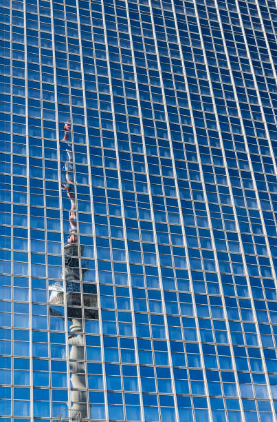 Black and white cityscape of a microwave antenna on a skyscraper in a busy business city.