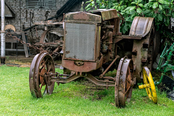 istock Old rusted and destroyed tractor abandoned outside on a rainy day 1138198163