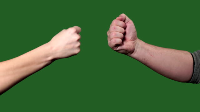 Chromakey. Green screen. Man and woman play hands in the rock paper scissors.