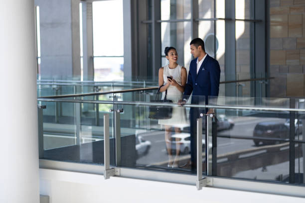 istock Front view of business people interacting with each other in office 1138198962