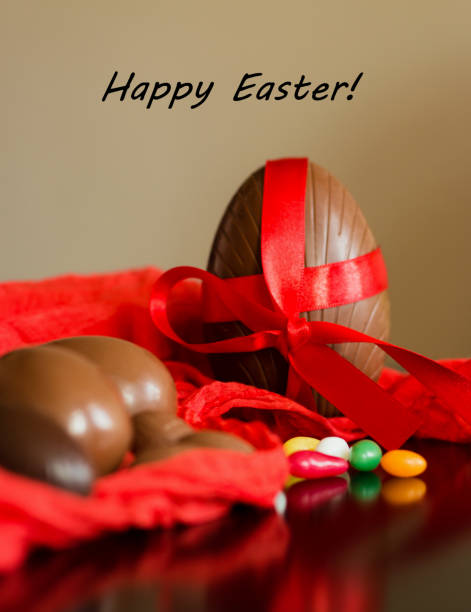istock Big and small chocolate Easter eggs decorated with red ribbon 1138199368