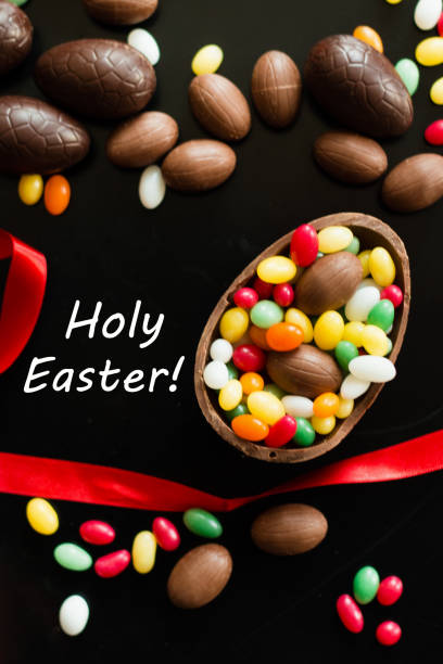 istock Big and small chocolate Easter eggs decorated with red ribbon 1138199921