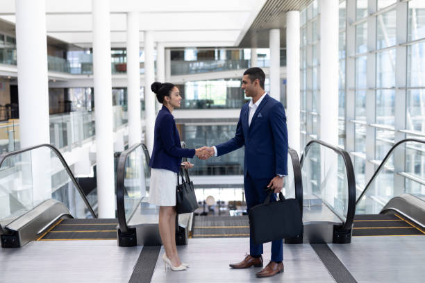 istock Young mixed-race business people shaking hand in modern office 1138201036