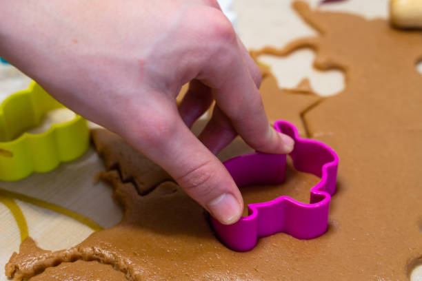 istock the process of cooking cookies at home. cut cookies from dough using shapes. 1138201092