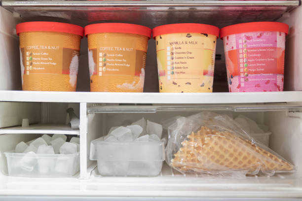 full of bucket container ice creams flavors and ice cubes in freezer. - quart imagens e fotografias de stock