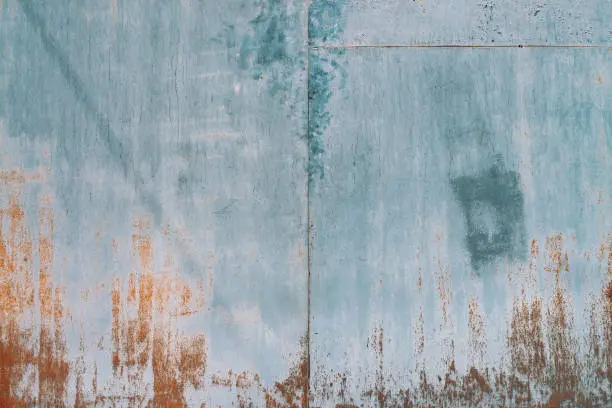 Photo of Rust on metallic surface. Iron texture. Partly rusty background. Rough oxide plate close-up. Hard decay of metal. Oxidation of steel. Chemical reaction. Partially rusted metal panel with peeling paint