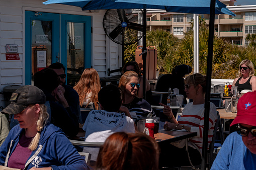 The Deck, bar and kitchen at Tybee. A popular destination for locals and tourists offers an eclectic menu with fresh seafood and a full bar. The patio seating has a view of the Atlantic Ocean and the beach. A perfect spot for lunch after a day at the beach. March-24-2019, Tybee Island, Georgia, USA