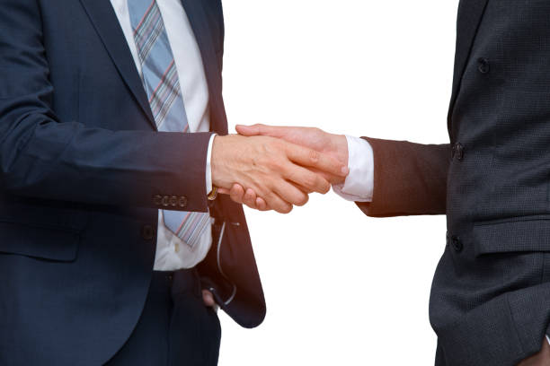 istock Two businessmen shaking hand together on white background; cooperation business with partnership 1138204685