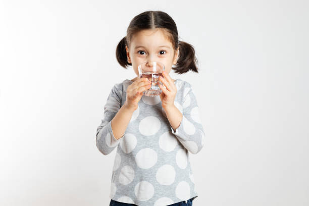 Girl Drinking Water Girl drinking water and is looking at camera. preschooler caucasian one person part of stock pictures, royalty-free photos & images