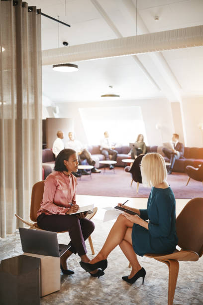 istock Two business colleagues discussing paperwork in an office 1138206828