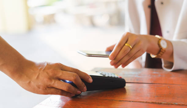 istock close up customer woman hand using smartphone for paying bill by using payment machine at table in the cafe , contactless payment concept 1138206969