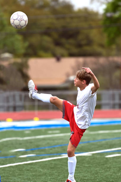 istock Young high school boy playing in a soccer game 1138207291