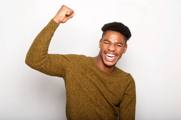 istock happy young african american man with arm raised 1138213165