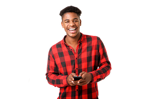 Front portrait of happy young black man holding cellphone against white background