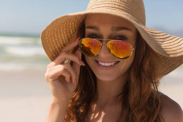 istock Young bikini Caucasian woman with hat looking over sunglasses 1138213976