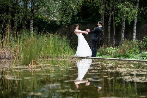 istock Just married bride and groom having fun in the park 1138214036