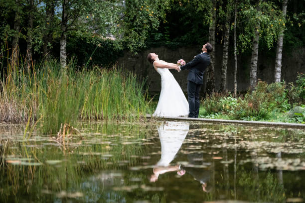istock Just married bride and groom having fun in the park 1138214044