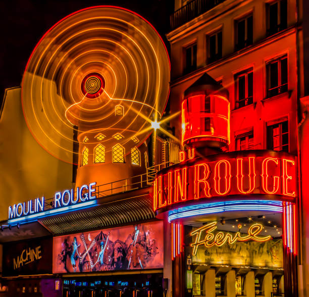 A night long exposure shot of the Moulin Rouge (red mill) - Image Paris, Île-de-France / France - May 3, 2011: A night long exposure shot of the Moulin Rouge (red mill) - Image place pigalle stock pictures, royalty-free photos & images