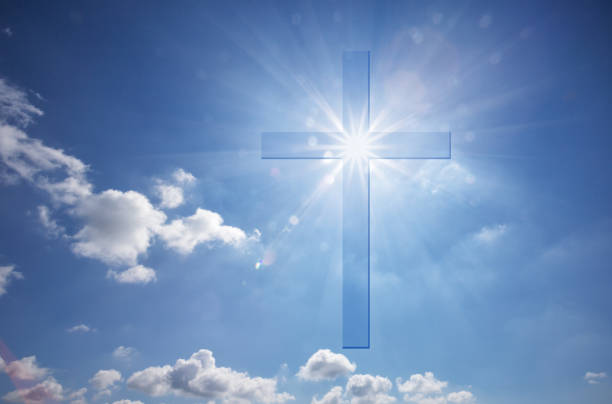 istock Christian shining cross in blue skies 1138216366
