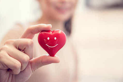 Woman hands hold Smile red heart. Valentine day love, Healthcare and medicine concept, copy space.