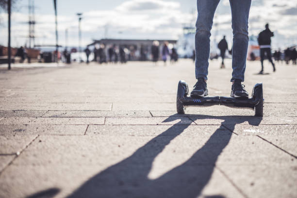 Front view of a man on a hover-board. Close up of man driving hover-board. hoverboard stock pictures, royalty-free photos & images