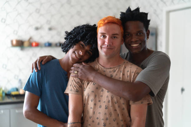 Three lovers / friends portrait at home Modern Gay Family multiculturalism photos stock pictures, royalty-free photos & images