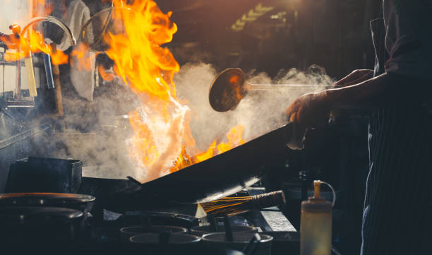 istock Chef stir fry in wok 1138223614