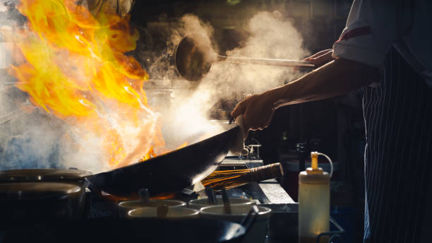 istock Chef stir fry in wok 1138223616