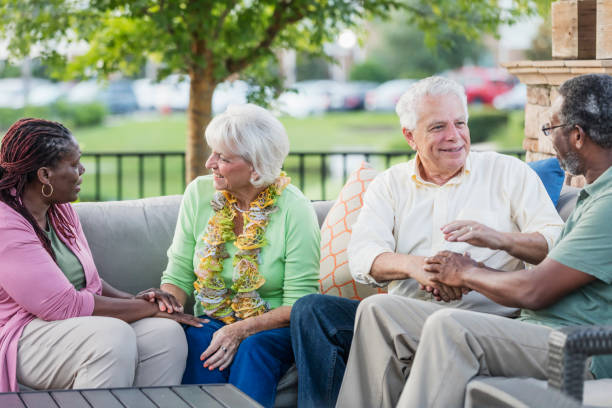 istock Two older couples hanging out on patio, conversing 1138223889