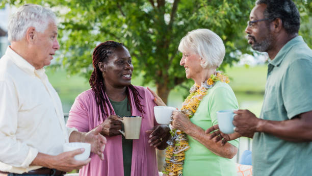 istock Two older couples hanging out on patio, drinking coffee 1138224052