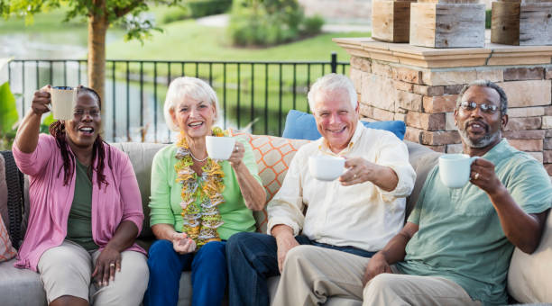 istock Two older couples hanging out on patio, drinking coffee 1138224055