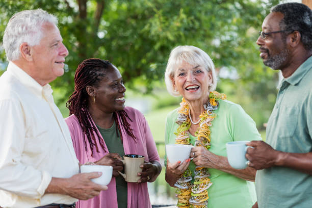 istock Two older couples hanging out on patio, drinking coffee 1138224179