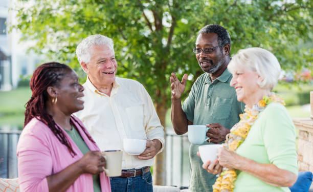 istock Two older couples hanging out on patio, drinking coffee 1138224292