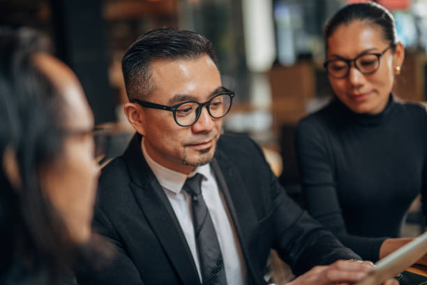 istock Business people sitting in restaurant 1138224905