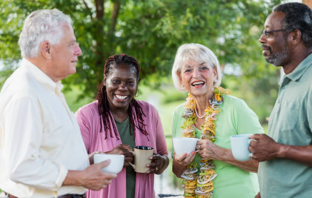 istock Two older couples hanging out on patio, drinking coffee 1138224975