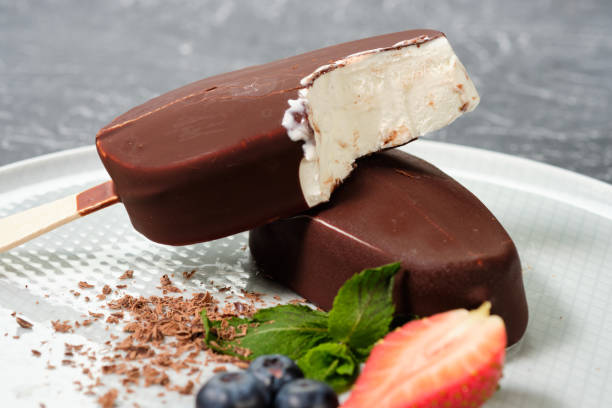 istock chocolate butter ice cream popsicles on the white plate with fresh summer berries, strawberries, blueberries 1138226762