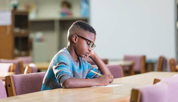 istock African-American boy in elementary school, writing 1138227082