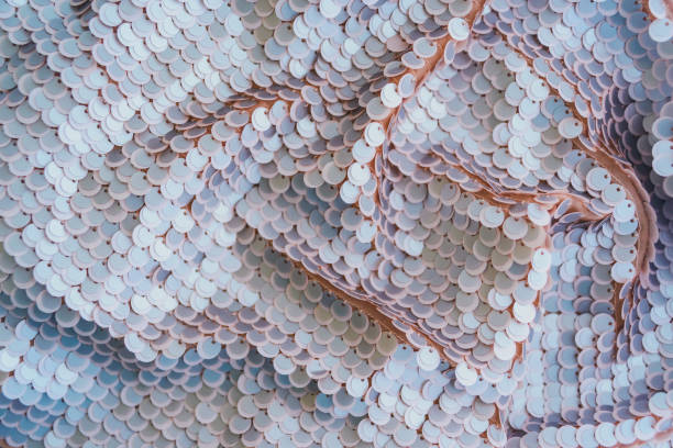 istock Pale pink shiny fabric with sequins, abstract background. 1138228031