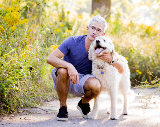 istock Smiling Senior Man Kissing Dog 1138228738