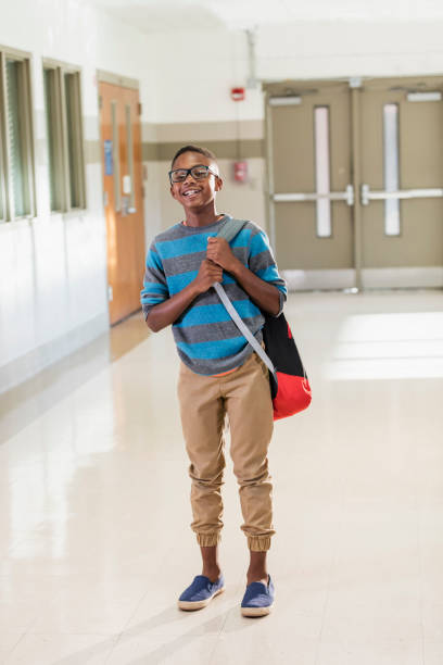 istock African-American boy standing in school hallway 1138228777