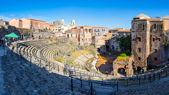 Catania, Italy - May 6, 2018: Panoramic view of ruins of the Roman theater of Catania (Teatro romano di Catania). Located in the historical center of Catania city, Sicily, Italy